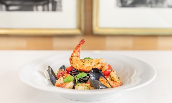 Black Squid Ink Pasta with grilled seafood , sun-dried tomatoes